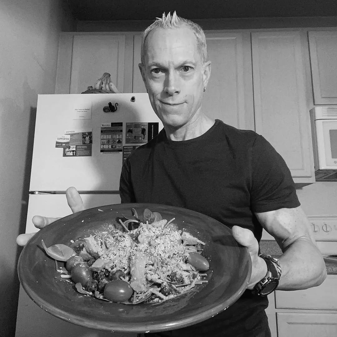 Rick Scott holding a plate of his Protein-Powered Minute Salad